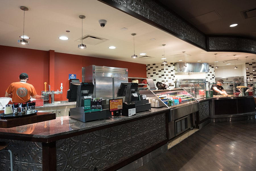 South Cantina service counter with checkout register and beverage cooler. 